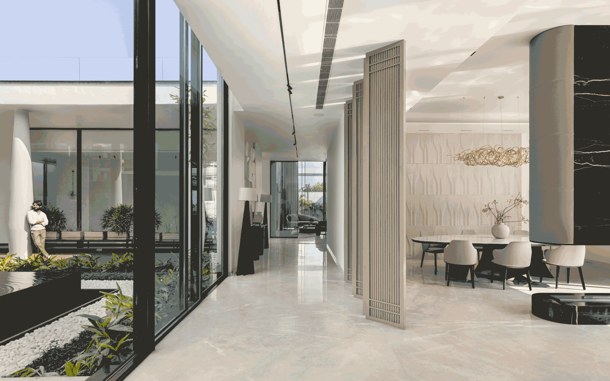 The formal dining area provides a clear view of the central courtyard. Minimalistic yet striking wooden louvres are practical masterpieces that deftly serve as a partition. Lighting by Hybec illuminates this modern residence. (Image Credits: Purnesh Dev Nikhanj)