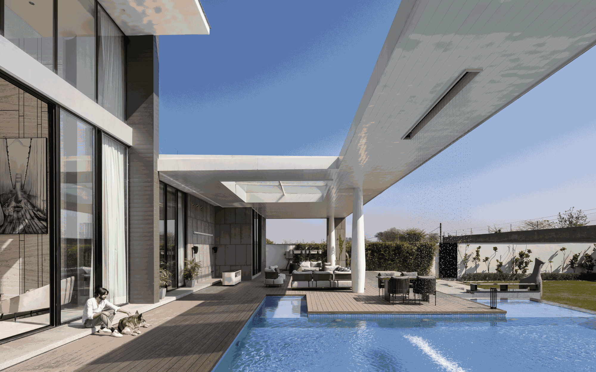 The house features a two-level backyard with a wooden deck, a pool, and ample space for family gatherings. Outdoor furniture curated from World of Outdoors by Rishi Bathla stands resilient against any weather. (Image Credits: Purnesh Dev Nikhanj)