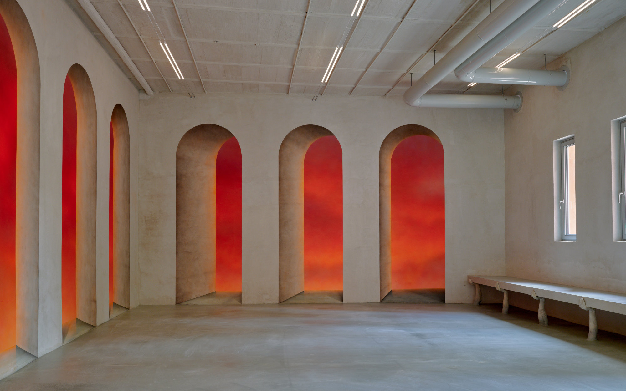 Drawing on Giorgio de Chirico, Christopher Page’s trompe-l’oeil arches bleed molten hues, while Clementine Keith-Roach’s sculpted limbs form unsettling, functional seating. (Image Credits: Jasper Fry) 