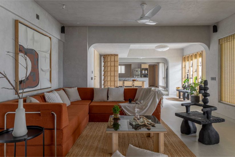 This 4-bedroom apartment in Pune is an ode to materiality. The flooring from Simpolo Tiles and Bathware, lighting fixtures from Litomatic and sculptural décor pieces from SoulofMache art studio ensure that the interiors never tip into austerity. (Image Credits: Viveekajeet Purohit)