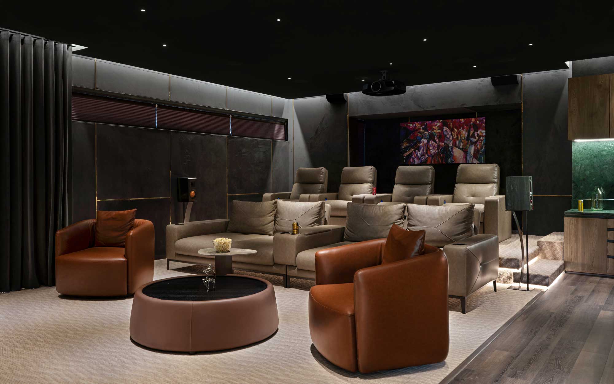 This home theatre featuring plush leather armchairs from Cassalino Furniture is softly lit by ambient lighting from Hybec. With Esquire managing the HVAC of the room that shares its space with a pantry and a bar, it is a perfect space for movie marathons. (Image Credits: Nayan Soni)