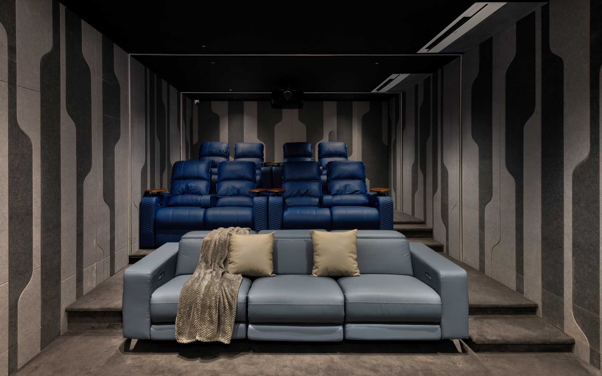 With sinuous parametric forms, layered acoustic materials from Sounds Good AV, and ambient lighting from Plus Light Tech, the home theatre transforms into an immersive, design-forward cinematic retreat. (Image Credits: StudioPhix) 
