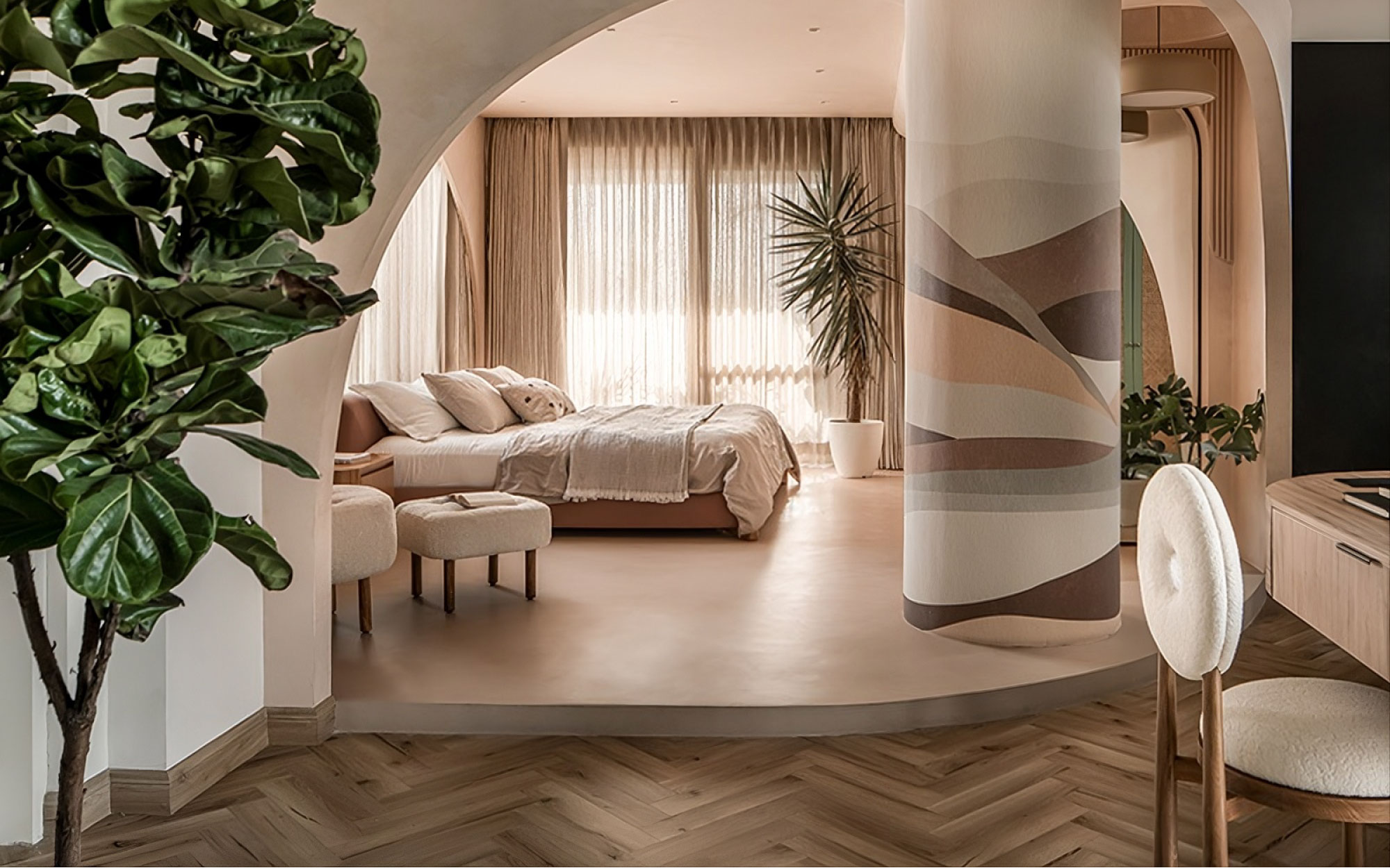 The primary bedroom with flooring by Holz Parker from DeCeramica, bespoke bed by Studio MNT, study chair by Quba Homes, study table by Precad Interiors, wallpaper from Design by Metamorph, lighting by White Lighting Solutions and curtains by Kapaas Furnishings sits beyond an arch, donning silhouettes of fluidity. (Image Credit: Ekansh Goel)