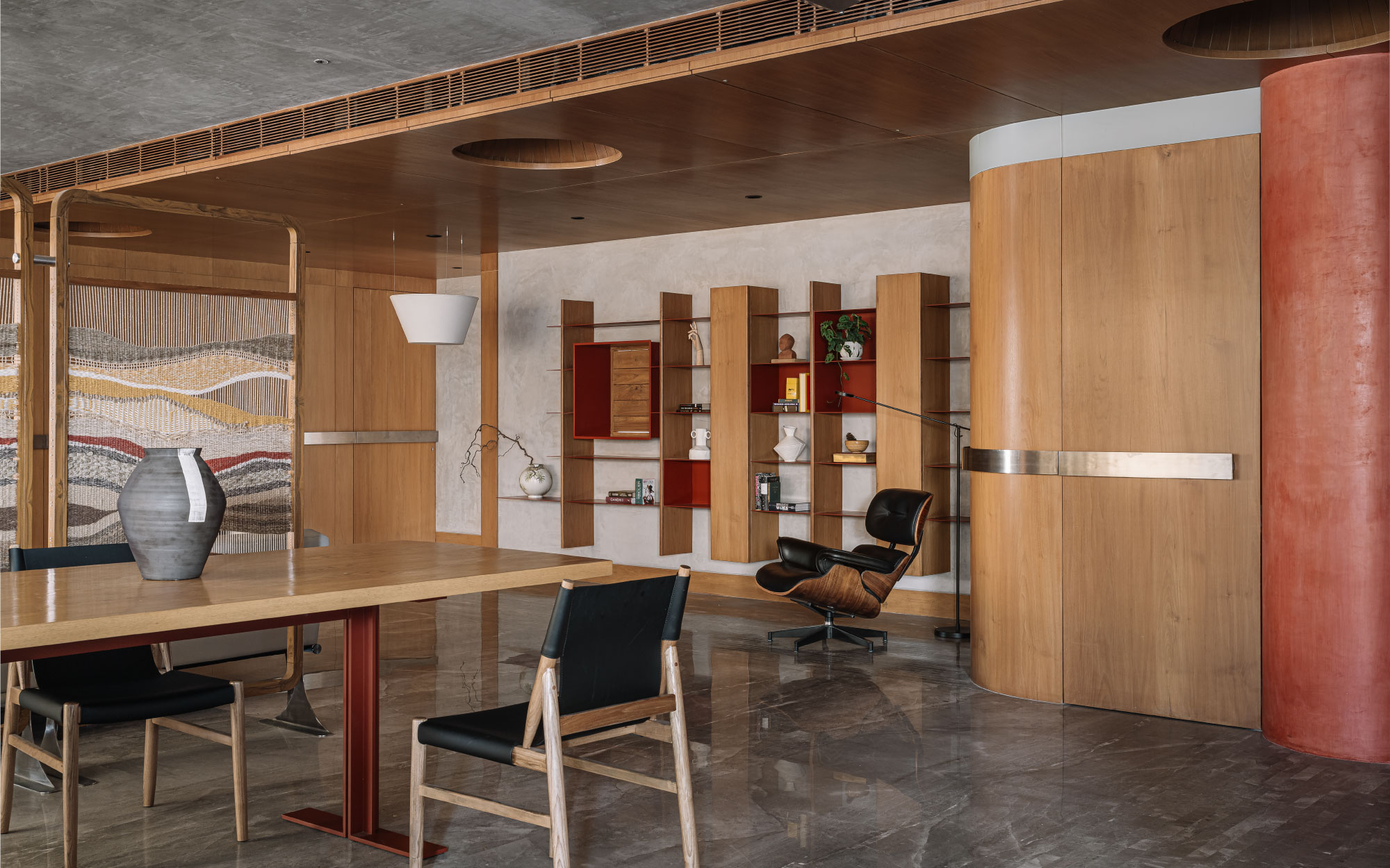 The living room with a gamut of shelves for displaying trinkets features custom lighting by H+A Studio and Smart Light, the furniture is by HM Studio, and the decor is by Shiv Shakti Furniture. (Image Credit: Ishita Sitwala)