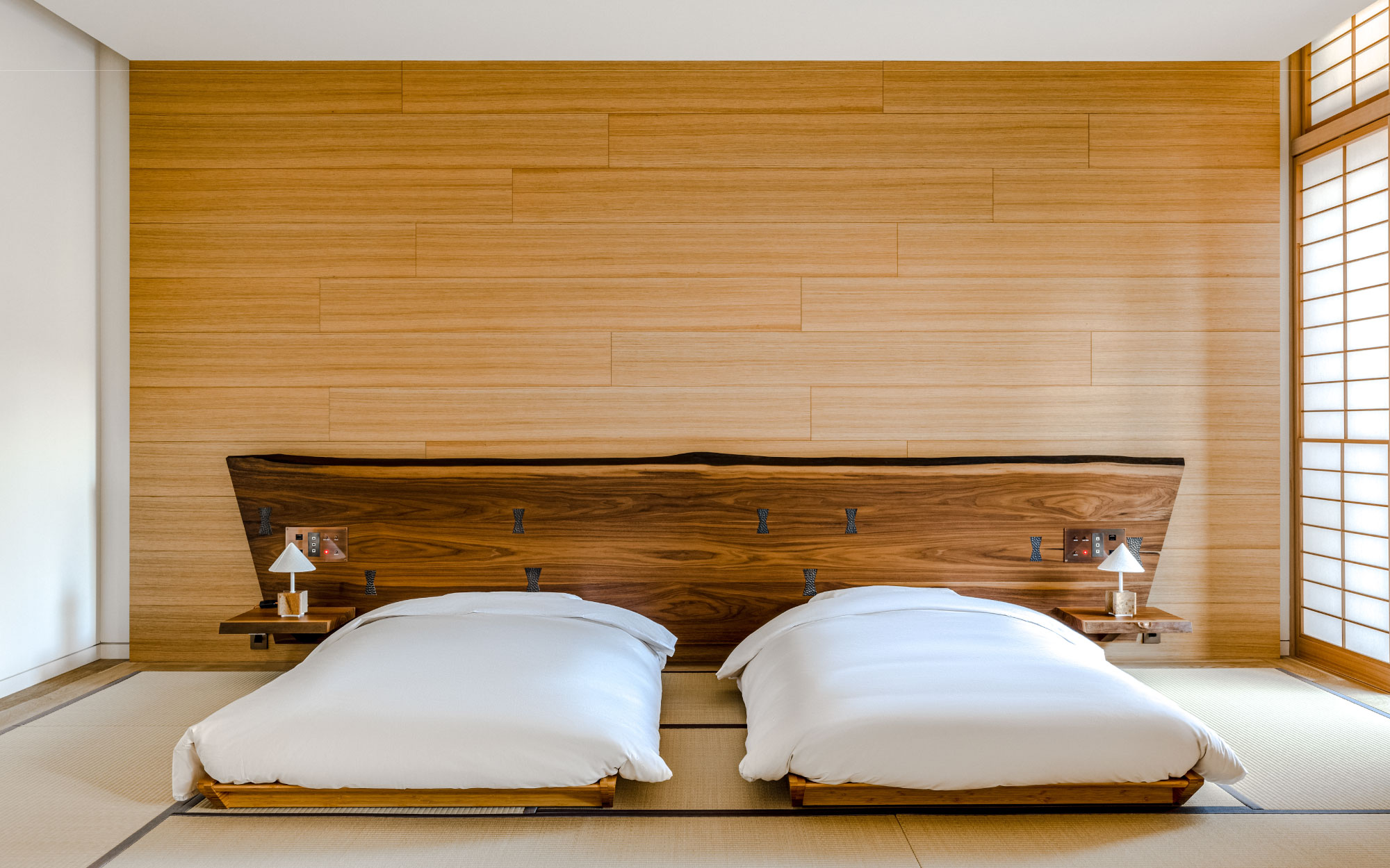 This one-bedroom suite features tatami flooring in the bedroom, IWATA twin futon beds and custom-made artworks. (Image Credit: Shinmonzen) 