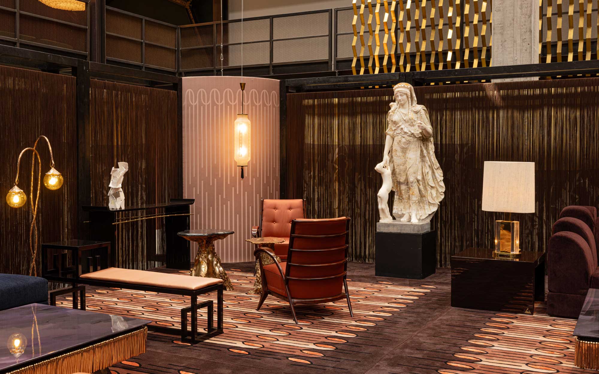 The ground floor unfolds through sculptural nooks of seating, where curated chairs, gilded accents, and statement objects gather in quiet clusters, shaping an intimate, atmospheric landscape of welcome. (Image Credits: Alejandro Ramírez Orozco)