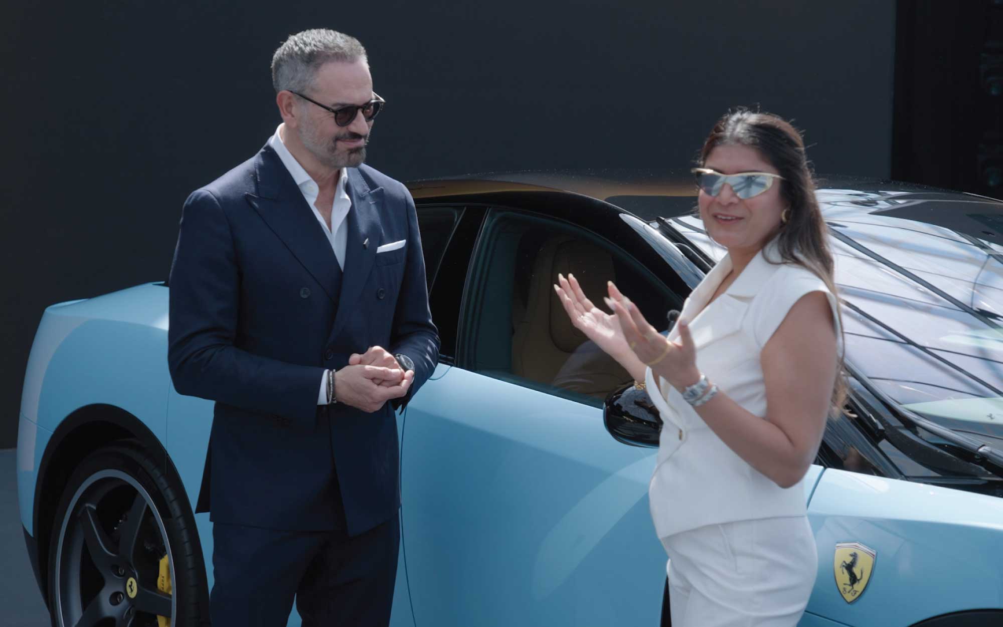 Design Pataki Founder Esha Gupta with Ferrari Chief Design Officer Flavio Manzoni beside the striking blue Ferrari Luce at its global unveiling in Rome. (Image Credits: Ferrari)
