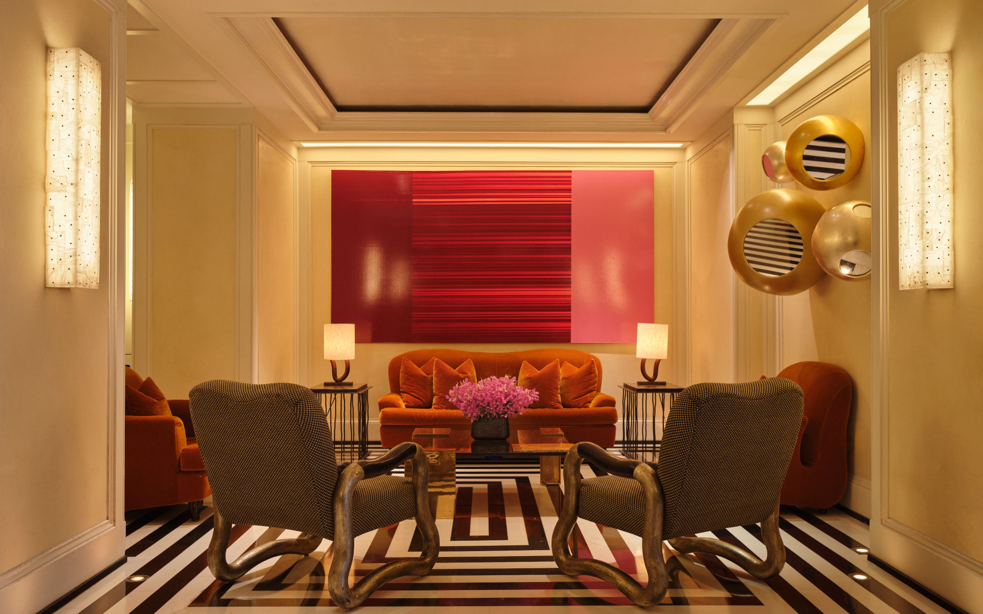 In the lobby of The Mark, the striking black and white flooring is anchored by a vivid red work, while the furniture is by Jacques Grange. (Image Credits: Adrian Gaut)
