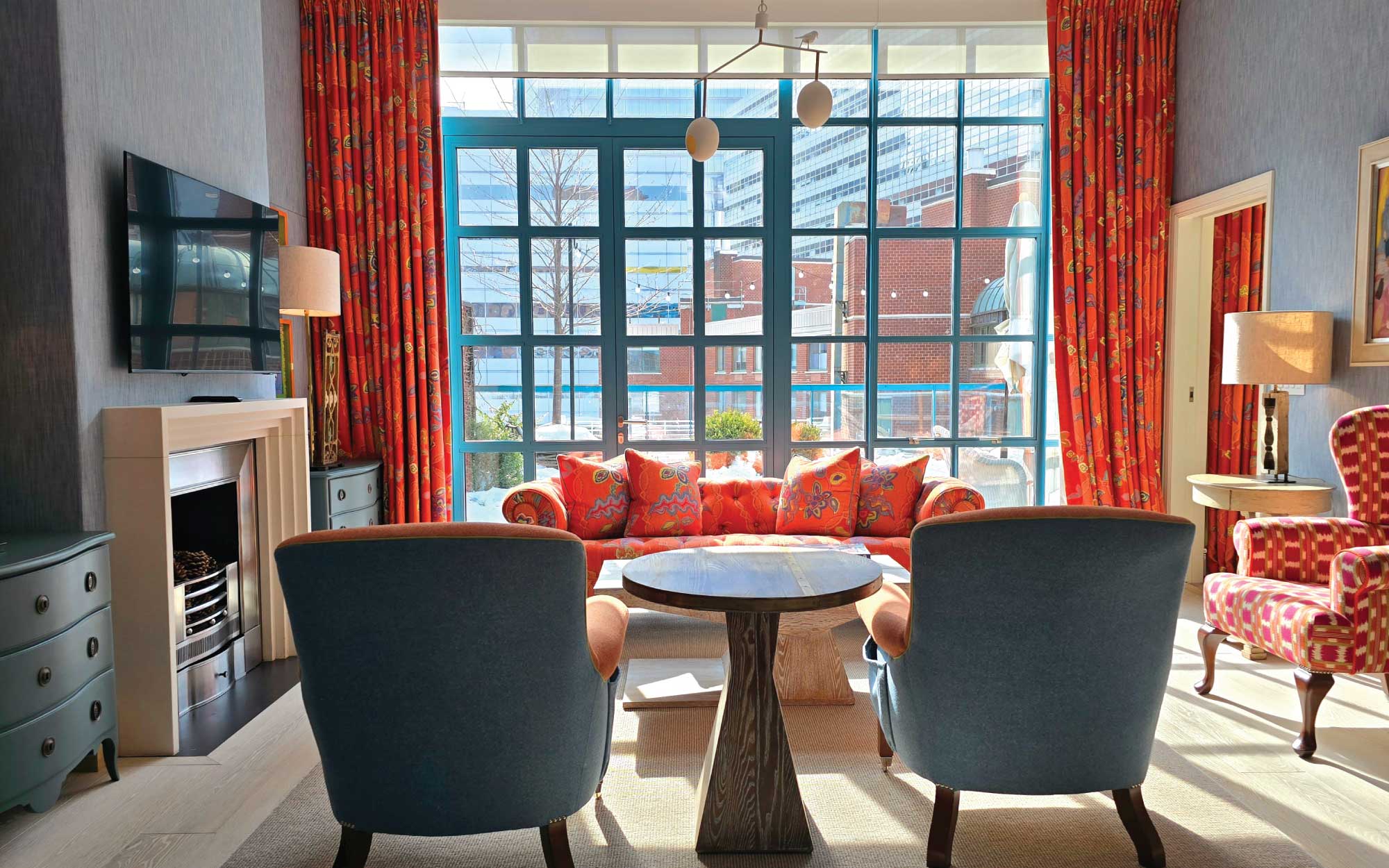 The terrace suites feature turquoise-blue, floor-to-ceiling windows that open onto a private landscaped garden, extending the living space outdoors. ( Image Credit: Warren Street Hotel, NYC) 