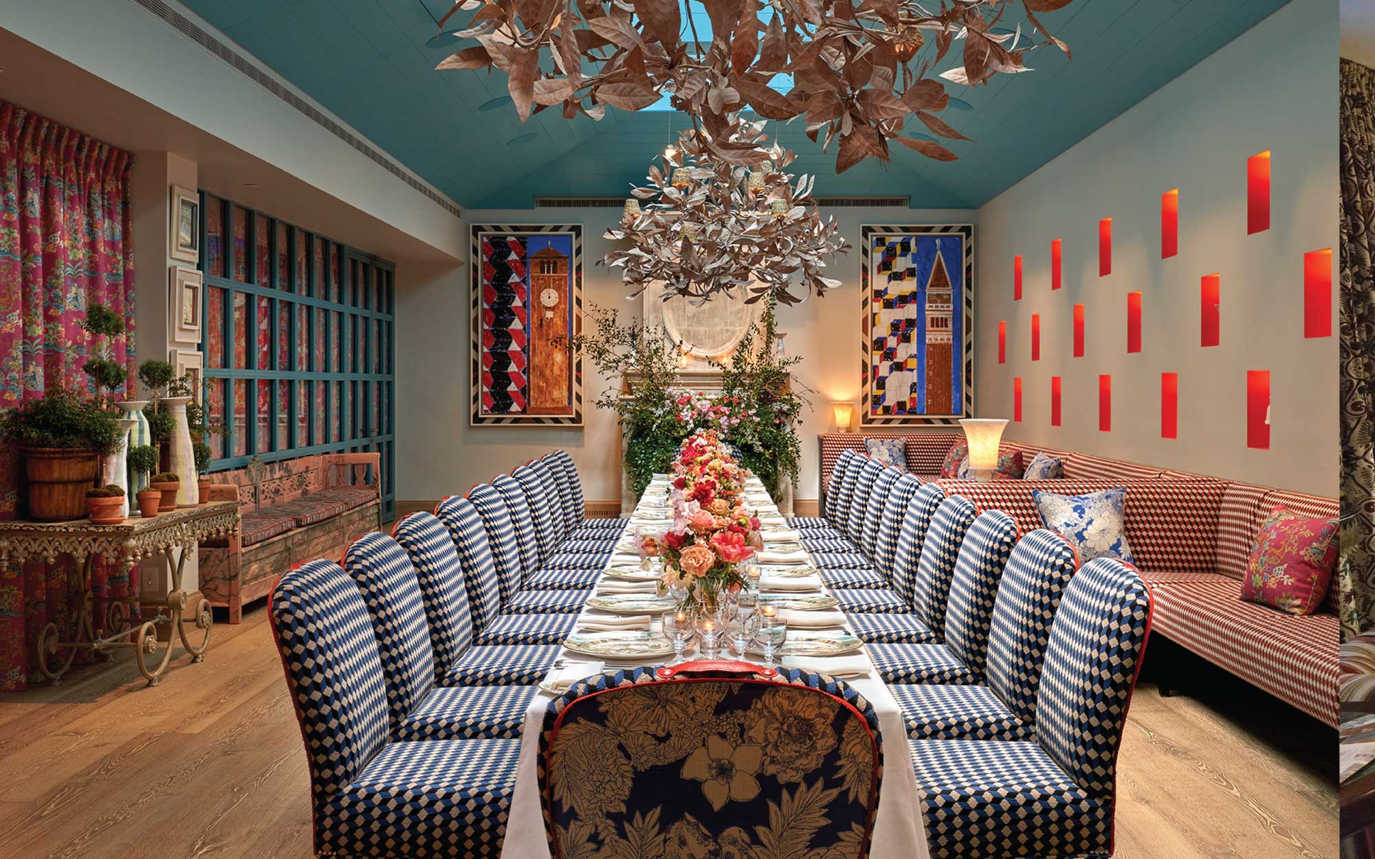 Dine beneath cast bronze chandeliers inspired by magnolia leaves, their sculptural form casting a warm glow, while porcelain pieces by Martha Freud illuminate the back-lit walls. ( Image Credit: Warren Street Hotel, NYC) 