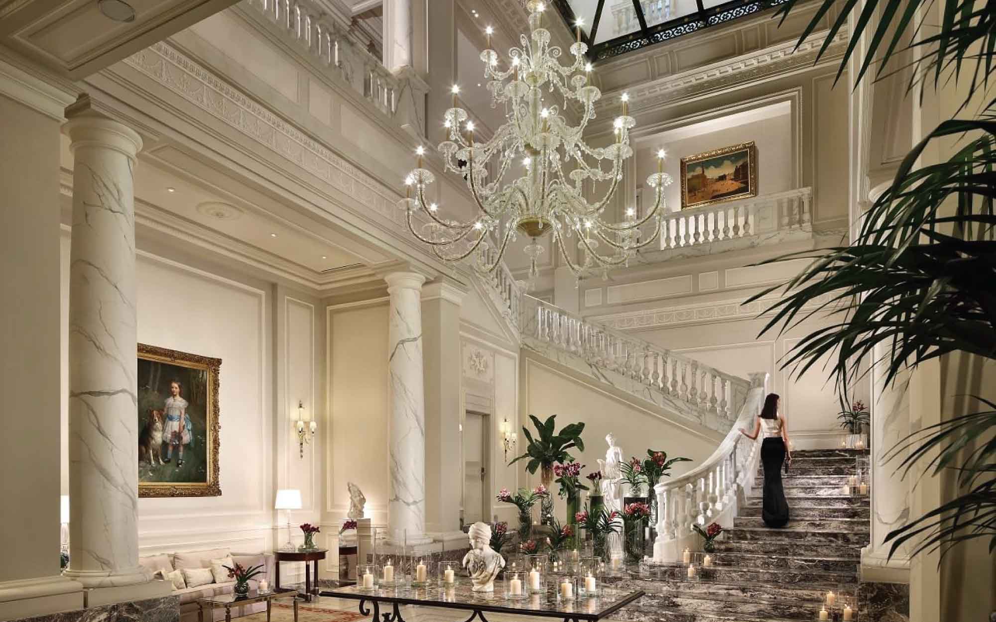 The lobby of Palazzo Parigi Hotel is especially striking, with polished marble floors, dramatic ceilings, abundant natural light, and the iconic sweeping staircase that gives the space a cinematic feel. ( Image Credit: Palazzo Parigi Hotel)