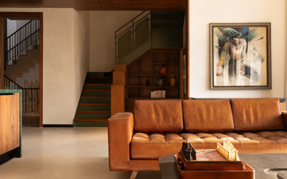 Part of the home’s quieter second-floor spaces, the family lounge is furnished with pieces from Portside Cafe alongside a Jaipur Rugs carpet. (Image Credits: Avesh Gaur)
