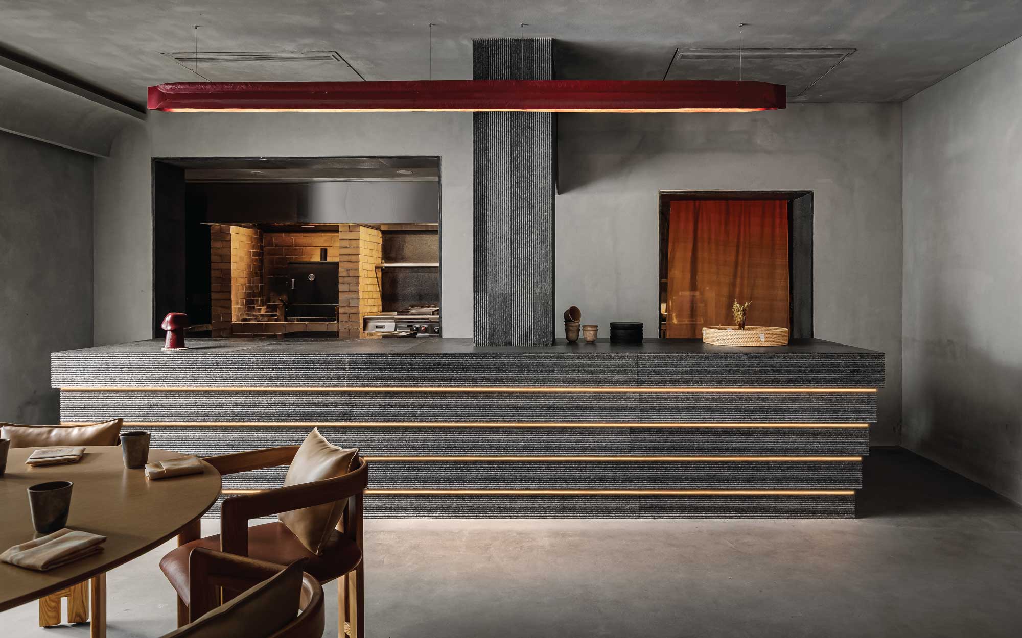Nila, designed by Designworx, places chefs at the centre of the experience, guiding diners through flavours that move beyond familiarity and nostalgia, and into new dining rituals in India. (Image Credits: Vedant Sharma)
