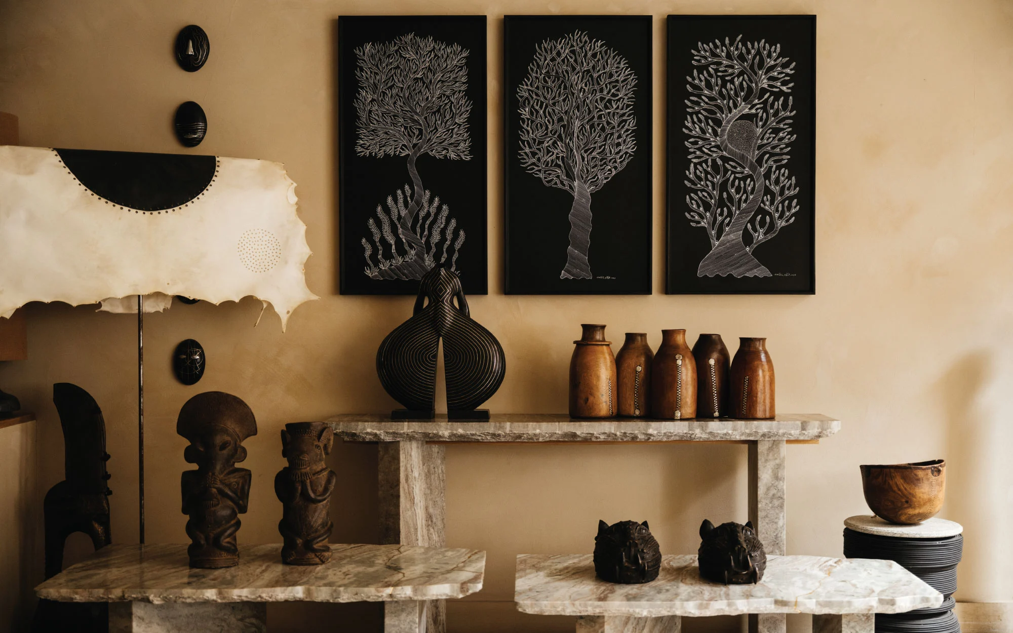 A glimpse inside the EVOKE, London store featuring Bidri works by Stephen Cox, Leather Akasha Lamp by Andrea Anastasio, Acrylic on blackboard by Ram Singh Urveti, artefacts like a Bamana headdress from Mali, Bamoun ceremonial clay pipe sculpture from Cameroon, Turkana wood bowl from Nigeria, Tutsi water bowl and a Bronze Benin leopard head sculpture from Nigeria. (Image Credits: Ellen Christina Hancock for EVOKE, London)
