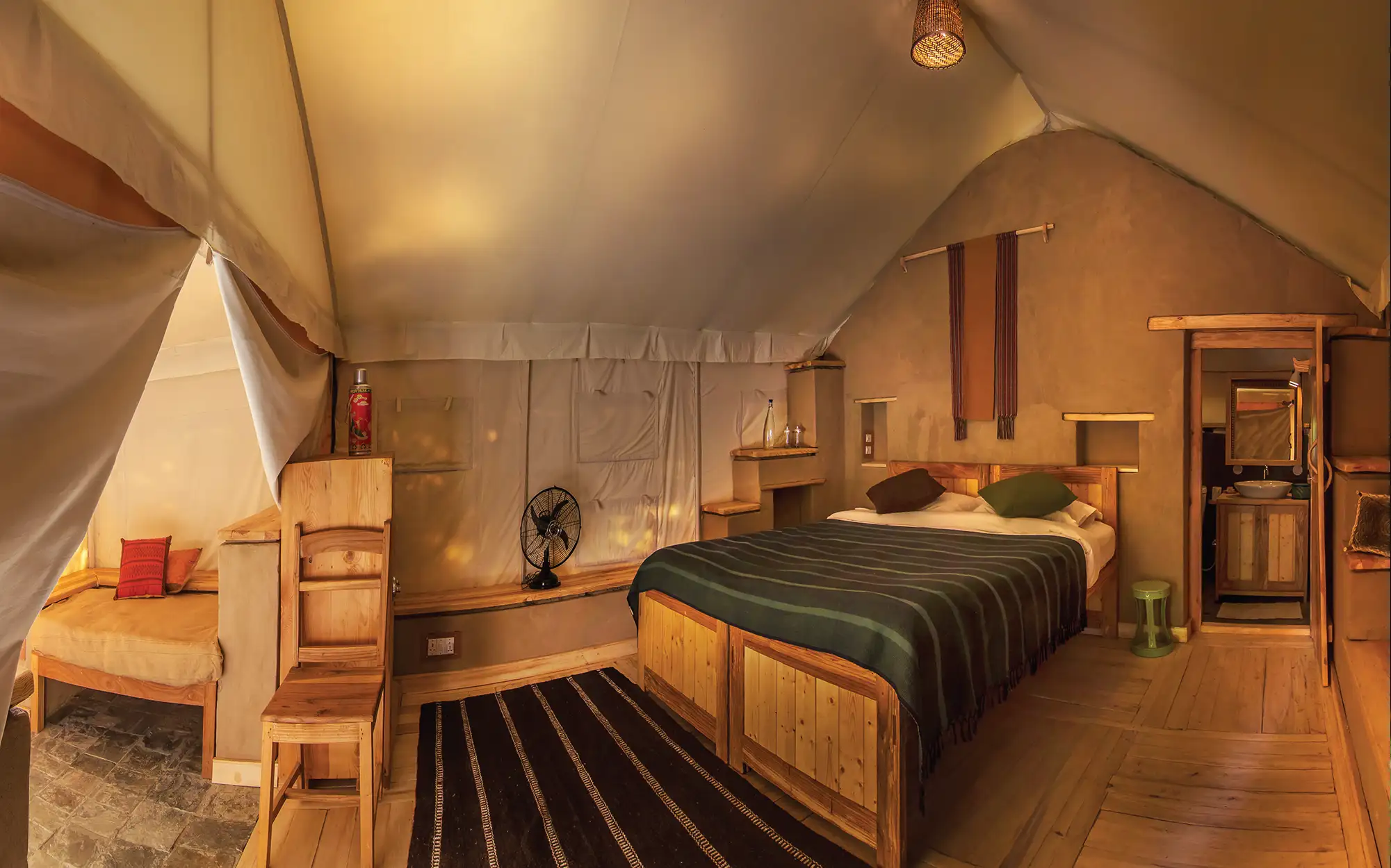 The seven orchard tents capture the essence of glamping, with spacious polycotton interiors and private porches overlooking the mountains. (Image credit: Nimmu House)