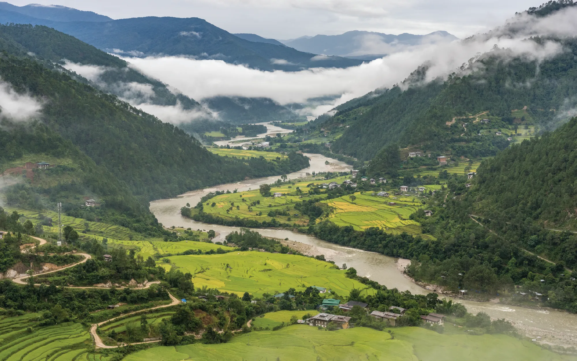 After hours of mountain roads and misty passes, arriving here feels more like discovering a hidden valley tucked away from the rest of the world. ( Image Credit: Marcus Westberg - Bhutan Tourism)