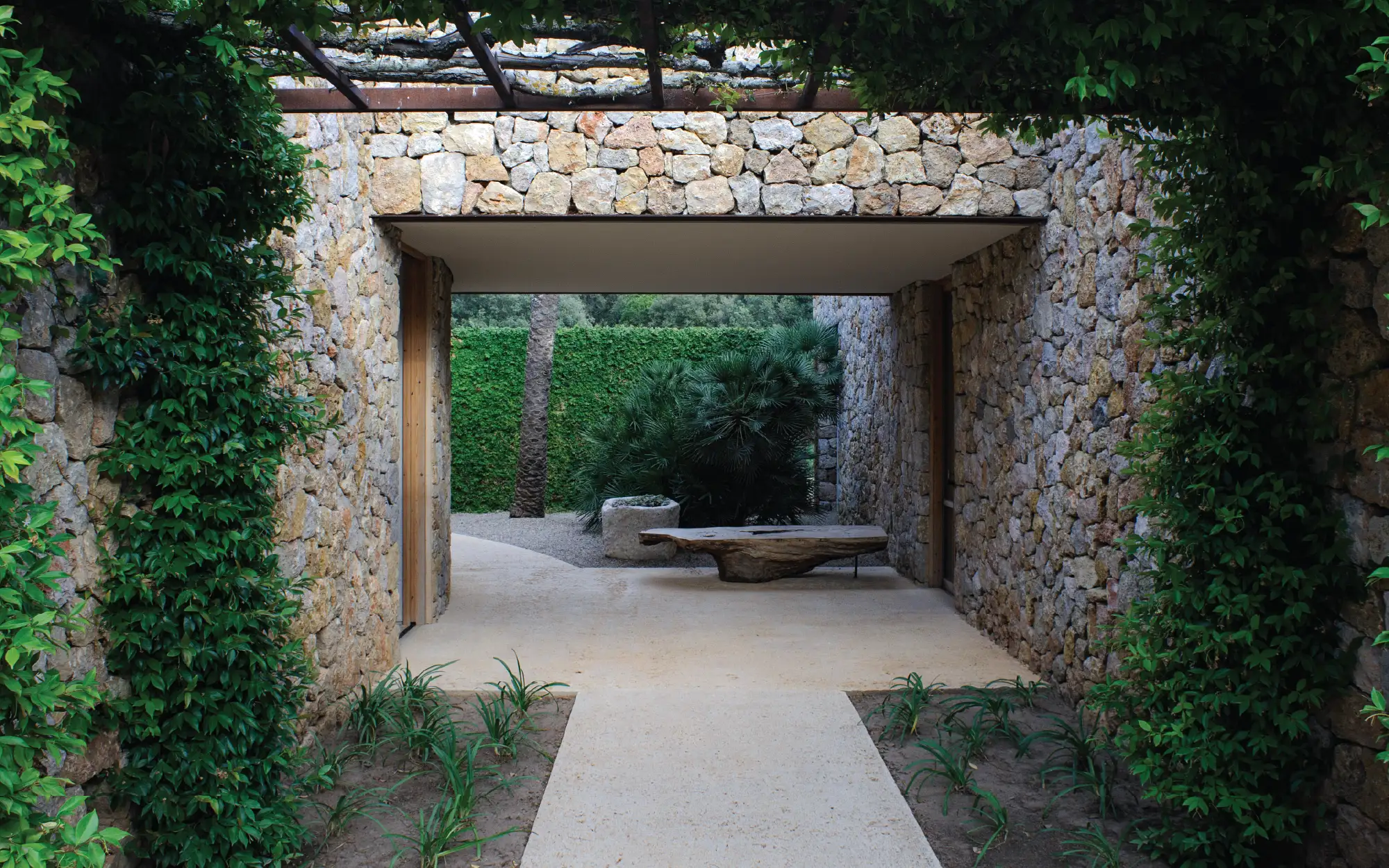 Es Racó blends understated architecture, native vegetation, and the rugged beauty of Mallorca into a tranquil retreat. (Image Credits: Jean-Marie del Moral)