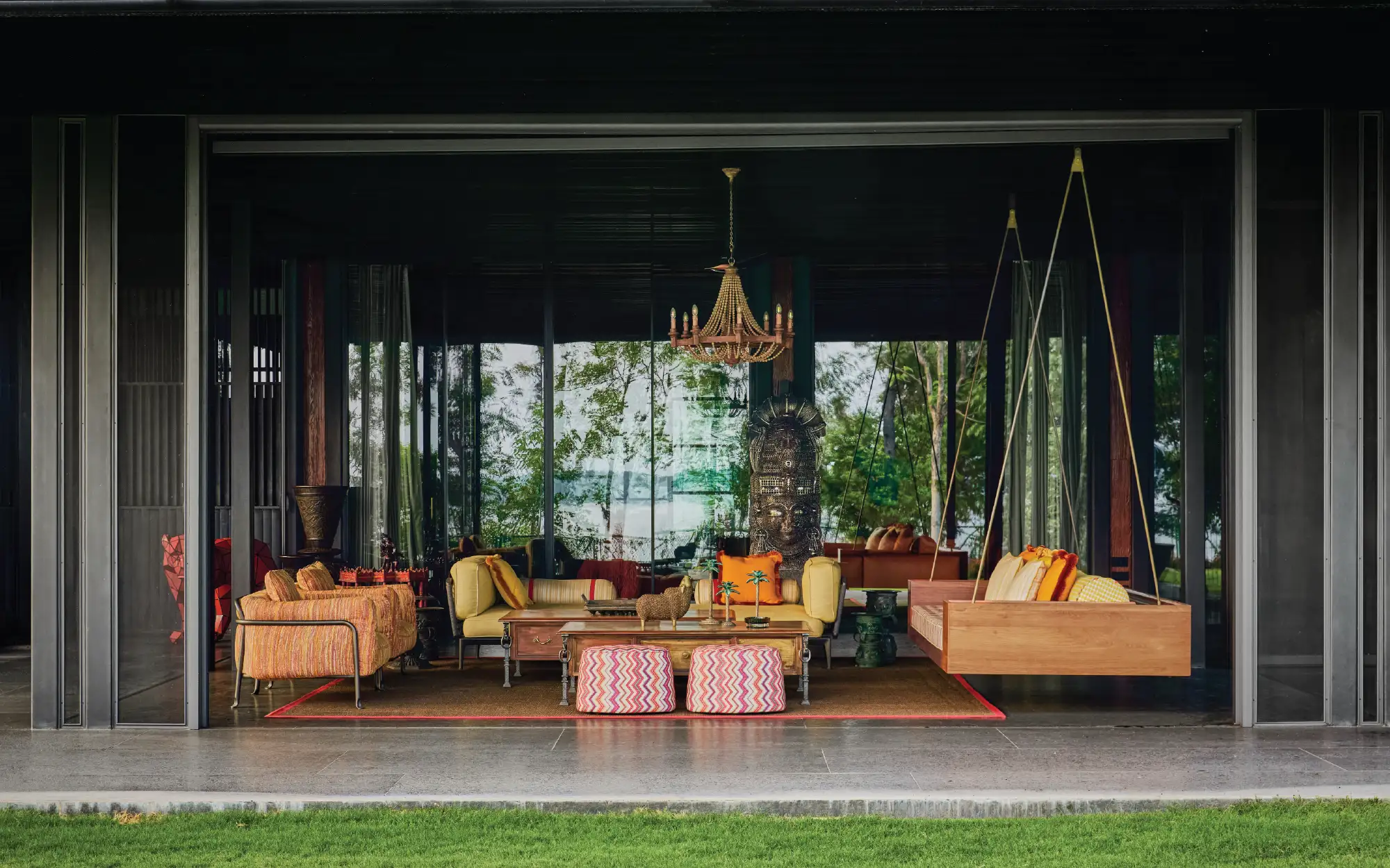 The main sit-out in the veranda brings the outdoors in with its spacious and airy vibe. The furniture reupholstered with outdoor fabrics from Studio Orion add an organic and tactile texture. The Vishnu sculpture from The House of Things is a conversation starter in the space (Image Credits: Talib Chitalwala)