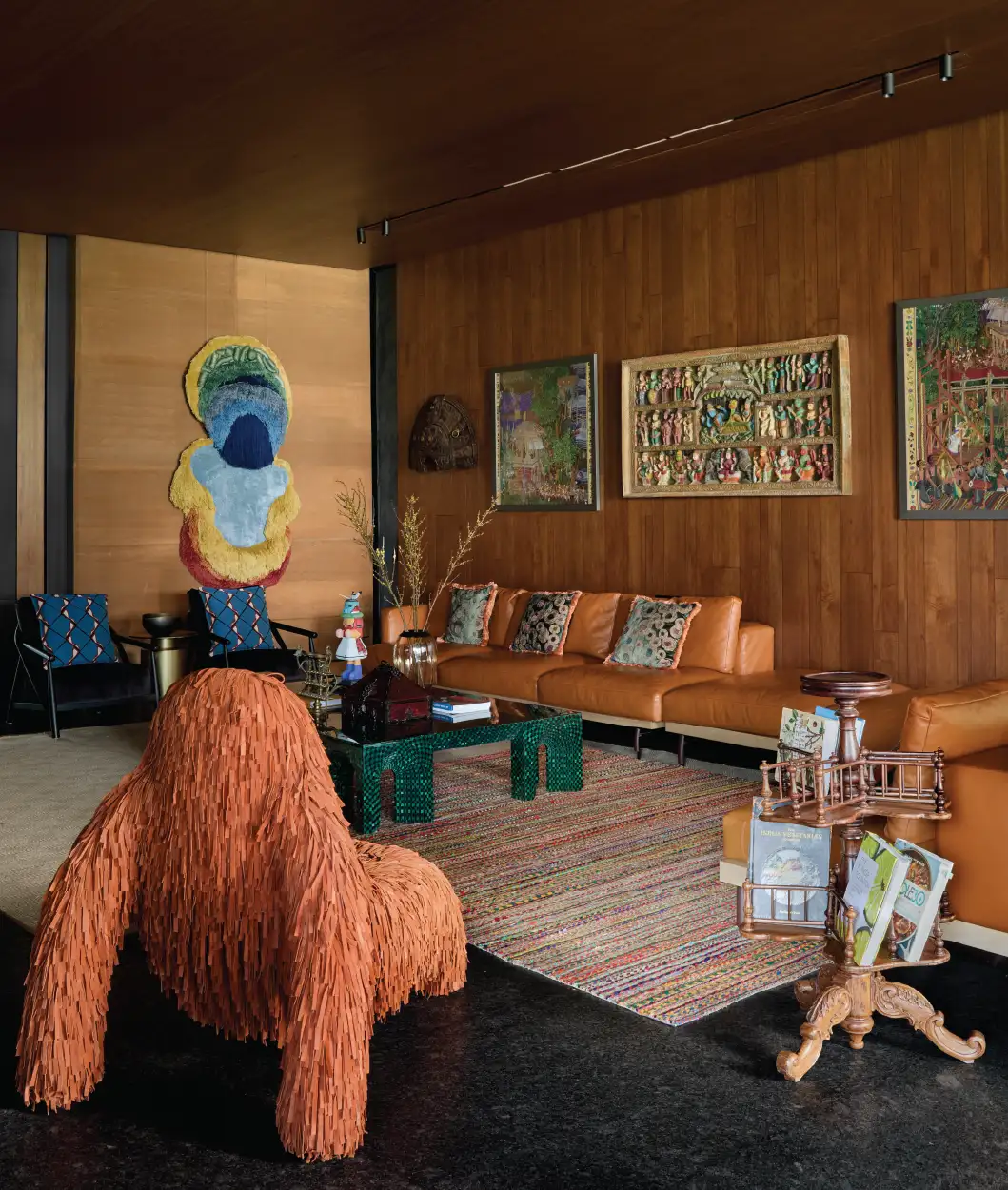 The Gorilla armchair from Scarlet Splendour is a conversation starter in the living room, as is the revolving bookcase from Heritage Arts in Kochi. The pair of textile artworks by Arinjoy Sen from Modern Art Gallery in Delhi and the Metamorphosis wall art rug by Lorenzo Vitturi from Nature Morte add a unique character to the walls. (Image Credits: Talib Chitalwala)